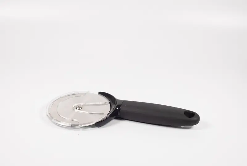 A stainless steel pizza cutter with a black handle on a plain white background, ideal for kitchen use